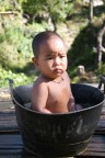 Myanmar - Young girl having bath in a tub Myanmar - Young girl having bath in a tub