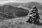 Vista del Lago di Como dalla cima del Monte Giumello. La zona e' frequentata da un gruppo di monaci tibetani, questo cumulo di pietre votive ne sono una traccia.