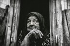 Elderly woman behind the counter in a small town Elderly woman behind the counter in a small town