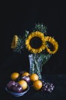 Sunflowers, apples, oranges and grapes
